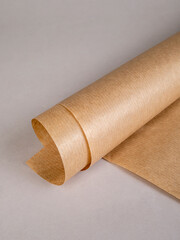 A roll of kraft paper on a gray background © Beliakina Ekaterina