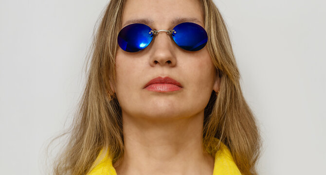 Portrait of beautiful woman face in blue glasses Matrix Morpheus