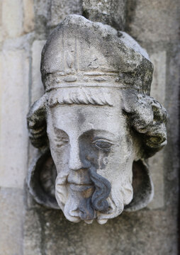 weeping abbot Weathered Stone Carved Head on Historic Church Exterior