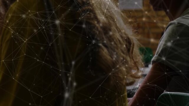 Hands typing keys initiating camera pulling back yellow student typing network flowing learning