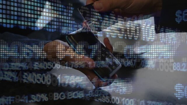 Merchant angling reader while customer inserting card, finance ticker scrolling, processing sale