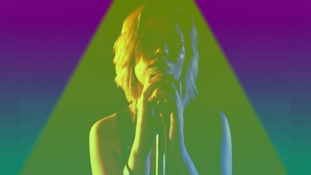 Camera revealing singer, cupping mic and singing for studio, triangles pulsing color across figure