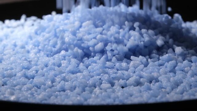 4K 4x Slow Motion Blue Bubblegum Candy Pellets Pouring on Black Plate
