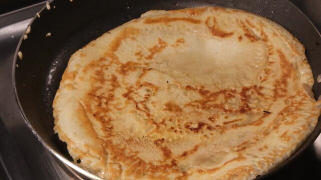 4K 4x Slow Motion Close Up Flipping Golden Pancake in Frying Pan
