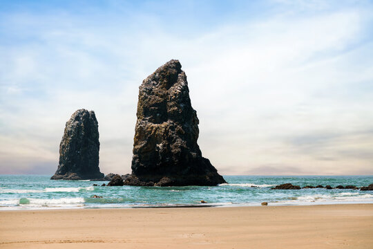 Visitors enjoying a sunny day at Cannon Beach, Oregon.