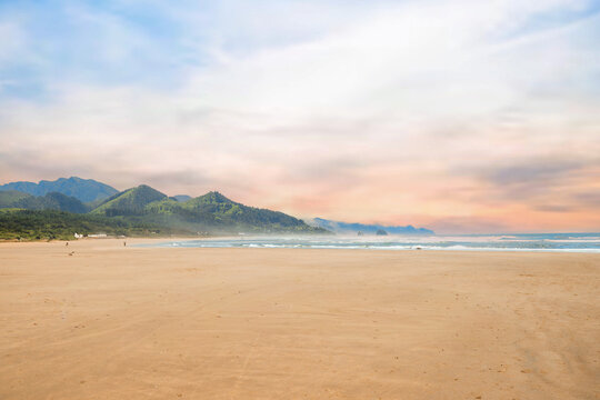 Visitors enjoying a sunny day at Cannon Beach, Oregon.