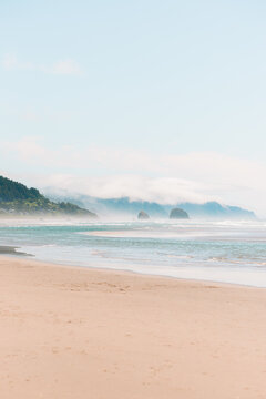 Visitors enjoying a sunny day at Cannon Beach, Oregon.