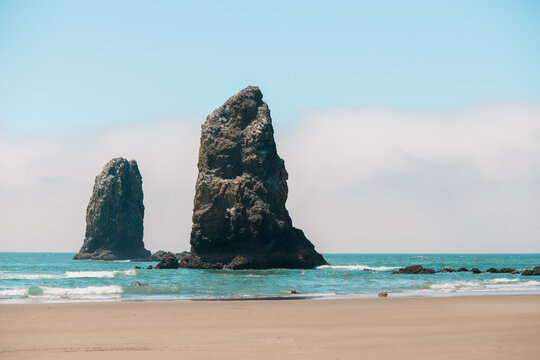 Visitors enjoying a sunny day at Cannon Beach, Oregon.