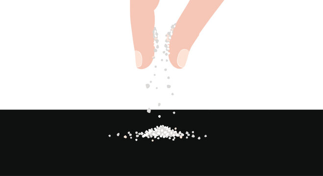 Human fingers are sprinkling fine white grains onto a solid black surface, creating a small and delicate pile at the bottom of the frame composition.