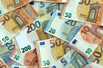 Fototapeta premium Euro money banknotes pile on table. Eurozone bills of EUR currency close up. Concept of economy