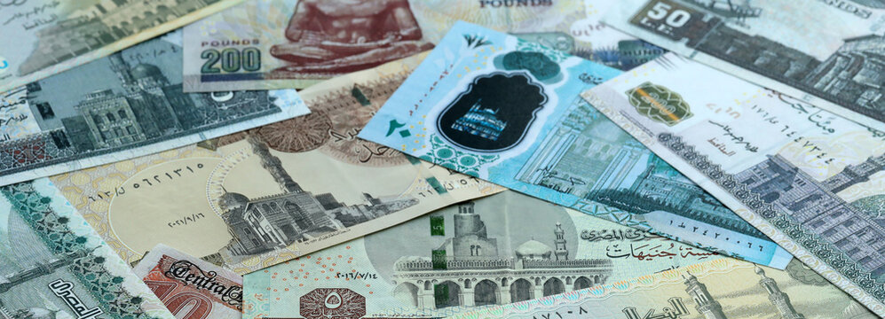 Egyptian pound money banknotes pile on table. Egypt bills of EGP currency. Concept of economy
