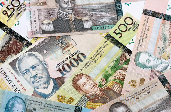 Haitian gourde money banknotes pile on table. Haiti bills of HTG currency. Concept of economy