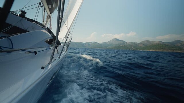 Boat In Lively Motion. Sailcraft Gliding Past Sunrise. Vessel Racing Through Frothy Ocean Waves. Powerful Wind Driving Sailboat Amid Crashing Surf And Spray