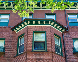 Classic Boston brick residential facade featuring detailed trim and elegant bay window architecture  © Baharlou