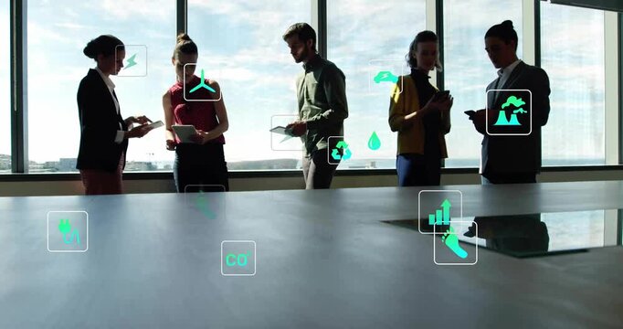 Team tapping screens as energy icons emerging, migrating toward devices to show energy metrics