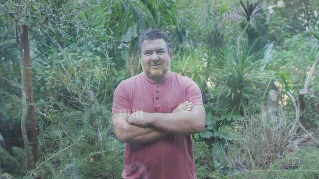 Diffuse daylight brightening senior man standing center shifting arms and smiling as camera zooming