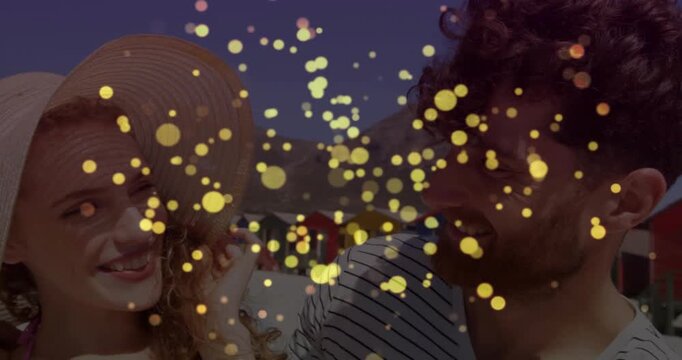 Particle overlay appearing at frame one, couple smiling, adjusting hat and leaning in, sharing joy