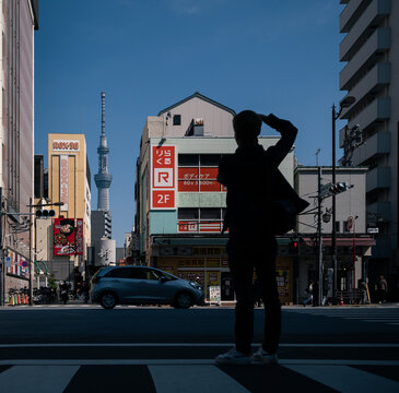Tokyo, Japan: photographer in front of Tokyo Sky Tree, a broadcasting and observation tower, in Sumida neighborhood