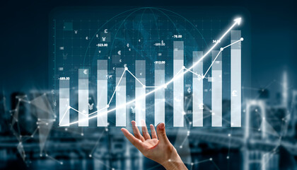 A digital representation of financial growth with hand reaching out towards an interactive graph....
