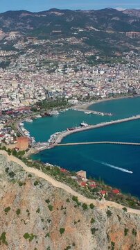 Aerial view of Red Tower (Kizil Kule), Alanya Marina and Mediterranean coast, T&uuml;rkiye. Taken with a drone.