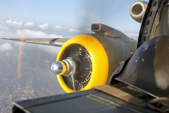 Aircraft in flight. Engine of a World War II bomber taken from the nose of the aircraft. B-25 Mitchell.