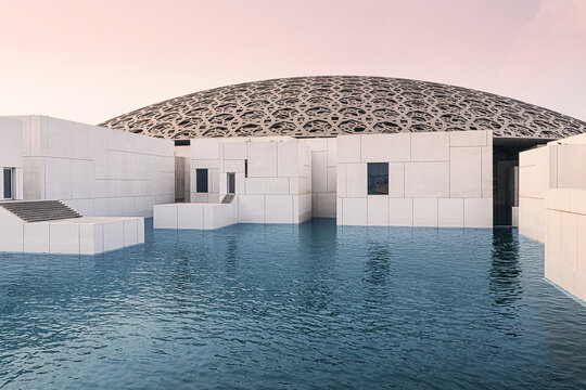 6 December 2025, Abu Dhabi, UAE: Louvre on Saadiyat Island, showcasing its iconic perforated dome and modern buildings surrounded by tranquil water