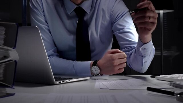 Businessman working late at night, typing on laptop, meeting deadlines and managing corporate finance administration. Audit and taxes in business