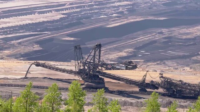 Big machine in open pit lignite coal mine moving dirt in quarry, slow motion