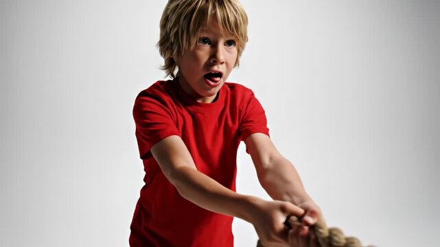 Young Boy Pulling Rope with All His Might.