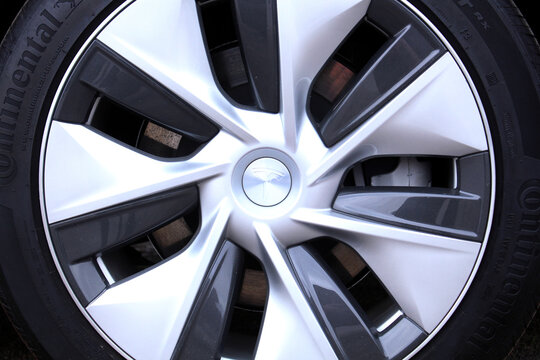 Vinnytsia, Ukraine; April 10, 2026. Close up Tesla Y wheel. Continental tyre. Tesla Wheel Alloy Wheels Rim. Glossy silver Tesla alloy wheel with black inserts and multi-spoke design mounted on black C