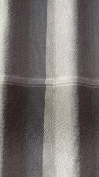 Closeup ondulin roofing tile texture shows corrugated waves and concentric ripple pattern, bitumen treated surface with overlapping.