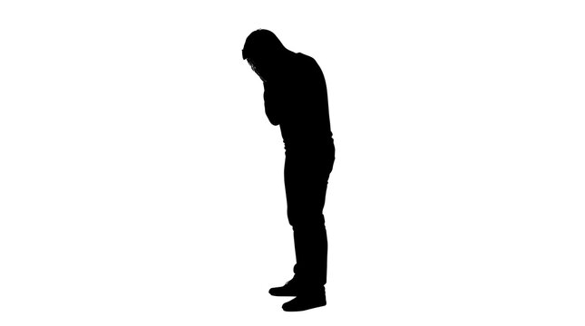 Silhouette of a man bowing his head in despair, isolated on transparent background