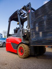 Forklift truck moving a large pallet in an industrial setting © Paul