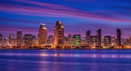 Fototapeta premium Vibrant San Diego Skyline Illuminated at Dusk, Reflecting on the Calm Water Below