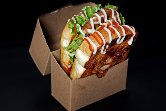 Korean Style Toasted Sandwich with Fresh Lettuce and Mayonnaise in Paper Box.
