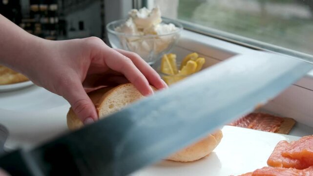  Slicing bread preparation . Tasty Food. Cutting Sourdough Bread On Kitchen. Making Morning Toast Breakfast Food.Fresh Crisp Sourdough Bread On Table. Quick Food. Cutting French Multigrain.