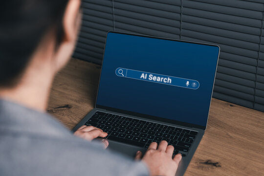 AI Search and Smart Information Discovery Concept. Woman using laptop with an AI search bar interface, representing intelligent search, fast information access, voice query, digital research workflow