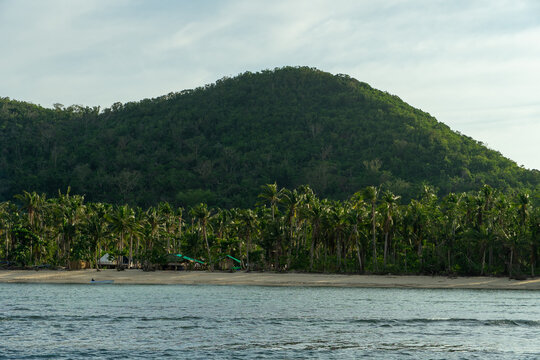 Bayang Basecamp from far, from a banca boat. Showing the beautiful beach with palms. In Palawan, The Philippines.