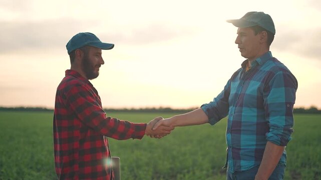 Handshake builds field trust partnership. Man handshake farmer means business agreement. Sunset handshake field shows farmer trust growing success partnership. Trust handshake supports teamwork goal.
