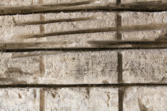 Textured shell rock wall in an old limestone quarry with saw marks