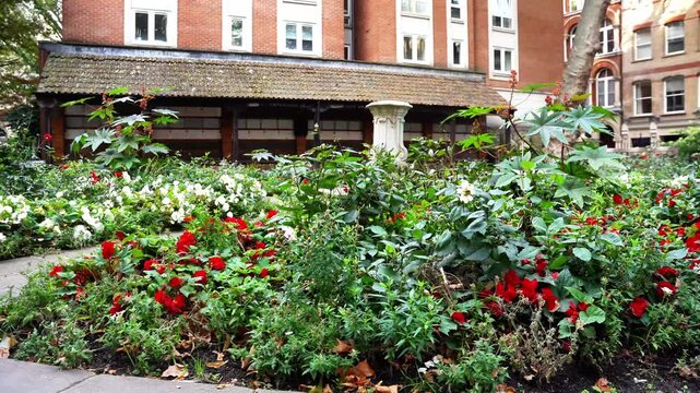 Footage of Postman's Park andMemorial to Heroic Self-Sacrifice, dedicated to ordinary people who died while saving the lives of others, near St Paul's Cathedral, London, United Kingdom