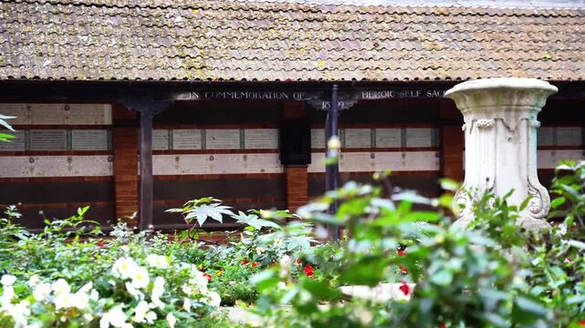 Footage of Postman's Park andMemorial to Heroic Self-Sacrifice, dedicated to ordinary people who died while saving the lives of others, near St Paul's Cathedral, London, United Kingdom