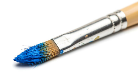Fototapeta premium Paintbrush with blue paint resting on a clean surface