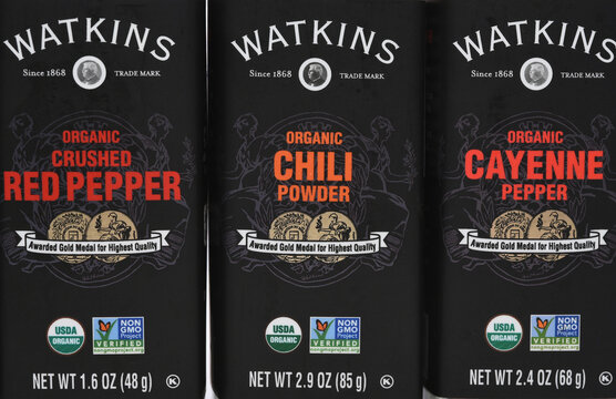 IRVINE, CALIFORNIA - 10 APR 2026: Closeup of the labels of three bottles of Watkins Spices, Crushed Red Pepper, Chili Powder and Cayenne  Pepper.