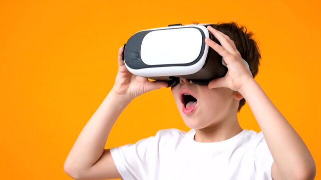 Excited young boy wearing virtual reality goggles.