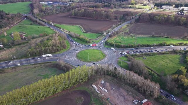The pulse of Scottish road transport at the Sheriffhall interchange. High-resolution footage of traffic flow on the A720 Edinburgh City Bypass during a bright day.