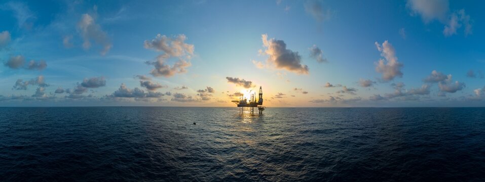 Aerial panoramic view of offshore jack up rig and offshore platform for oil and gas exploration and production.