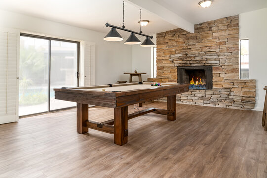 Rustic style solid wood pool table, spacious game room, rock fireplace