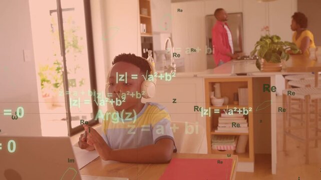 Vertical video: Child typing laptop doing math while lesson starting, math overlay over child