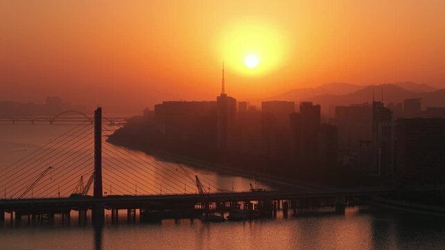 Golden hour over Qian Tang River and Bridges with Hangzhou Cityscape at Sunset